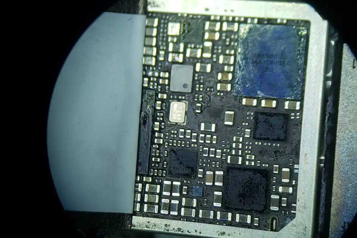 Close-up of an iPhone 7 logic board having its EMI shielding removed to access the audio IC for repair.