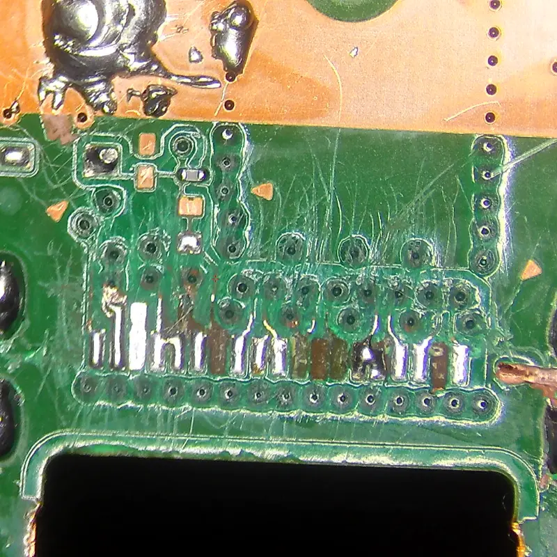 PS5 HDMI port with ripped solder pads and damaged traces from failed DIY replacement attempt