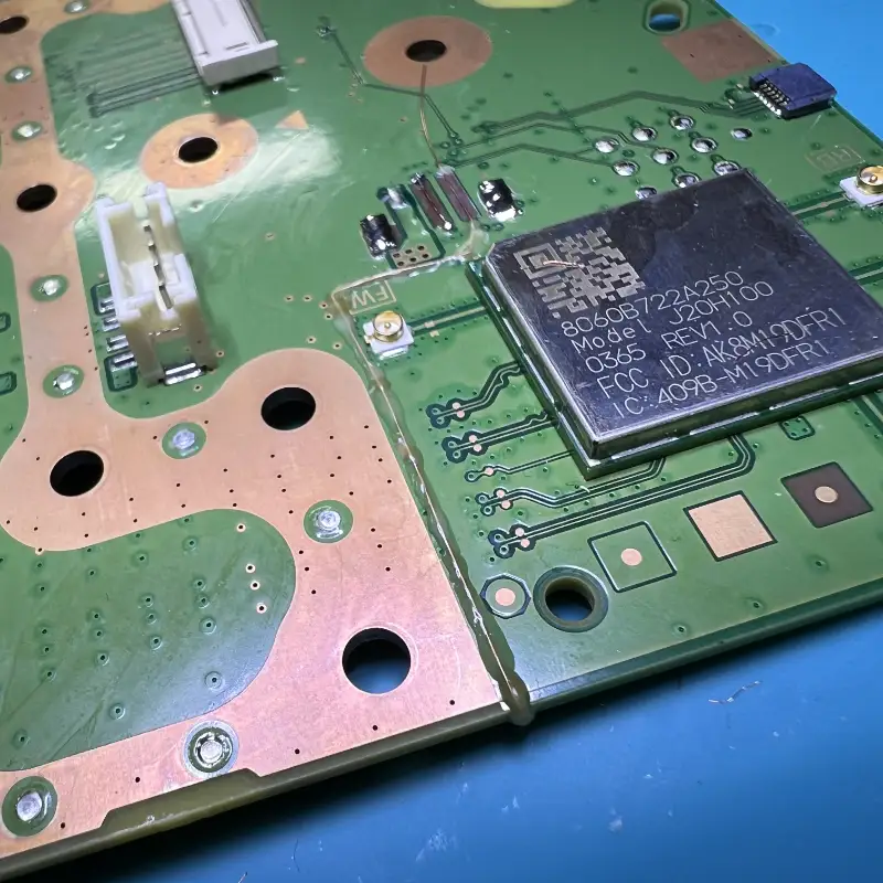 PlayStation 5 motherboard fan connector jumper wire microsoldering repair showing advanced trace reconstruction at Seki Gadgets professional console repair workshop in Canberra ACT