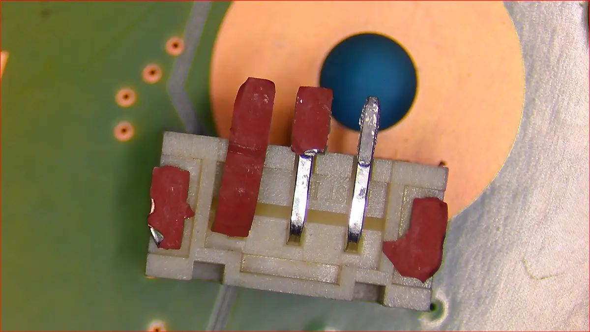 Detailed view of torn PS5 fan connector showing ripped solder pads and damaged traces