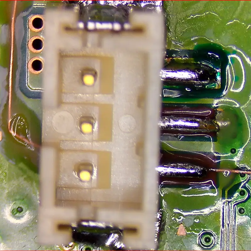 Long jumper wire repair on PS5 fan connector showing extended trace reconstruction