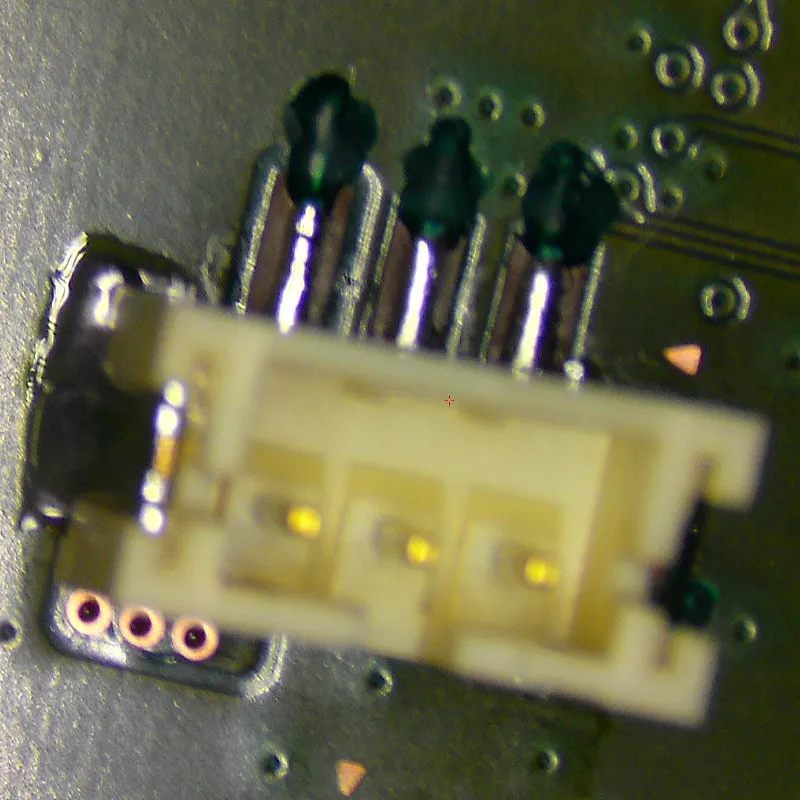 Completed PS5 fan connector trace reconstruction showing professional microsoldering repair