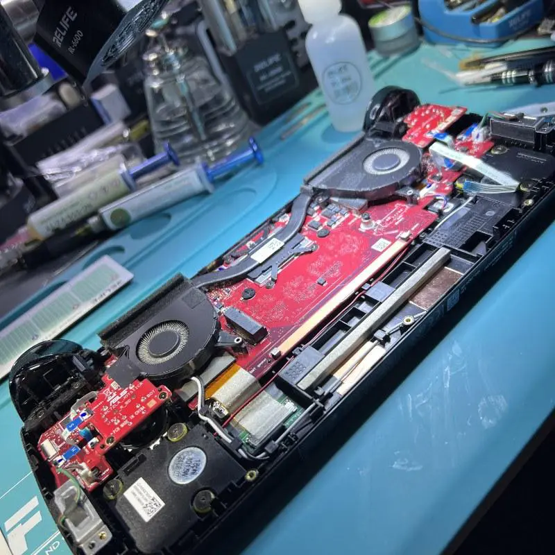 ASUS ROG Ally X opened on the bench at Seki Gadgets Canberra workshop showing the motherboard and cooling fan